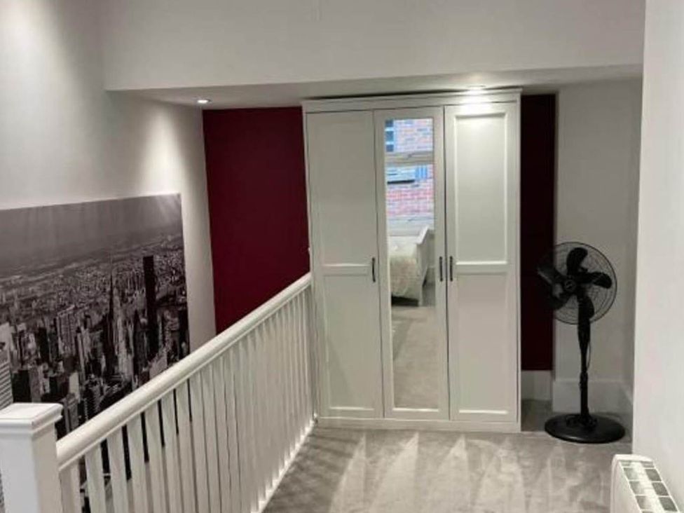 A hallway with a wardrobe and a fan at Family Friendly Apt Sleeps 6 Station Close in Royal Tunbridge Wells