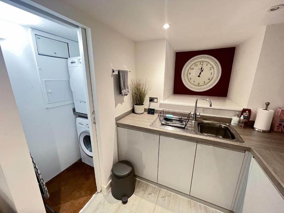 A kitchen area with sink and cabinet at Family Friendly Apt Sleeps 6 Station Close in Royal Tunbridge Wells