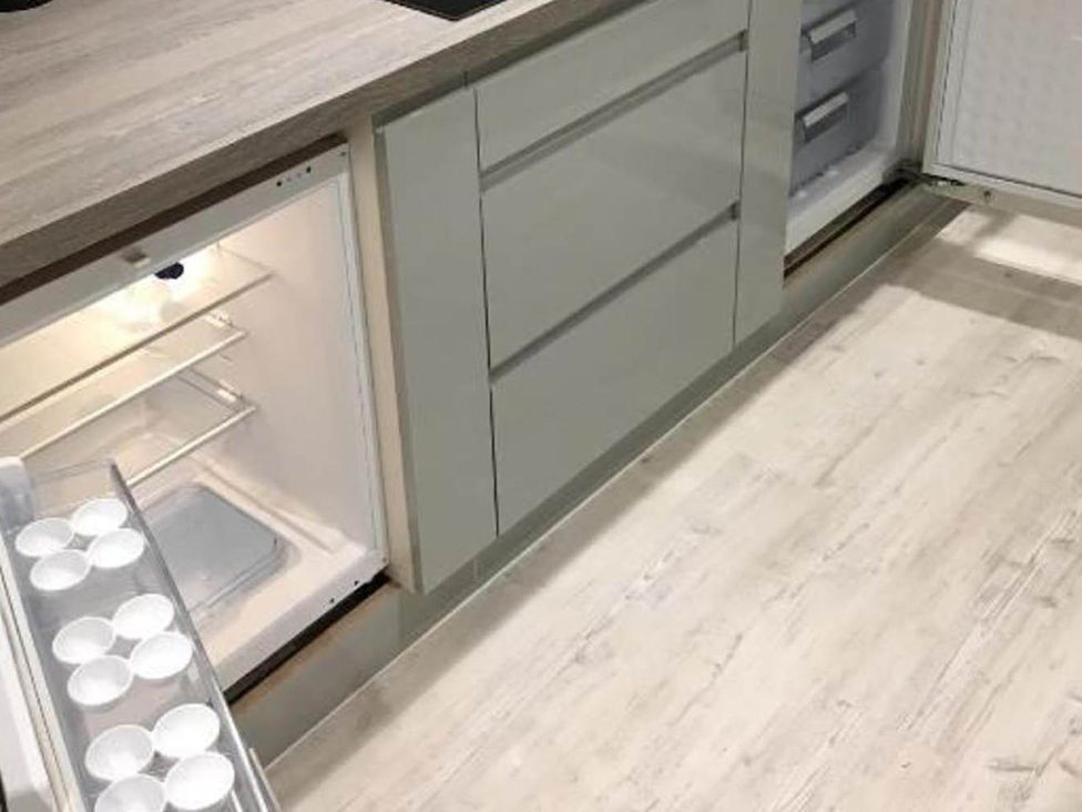 A refrigerator with open door in a kitchen at Family Friendly Apt Sleeps 6 Station Close Royal Tunbridge Wells