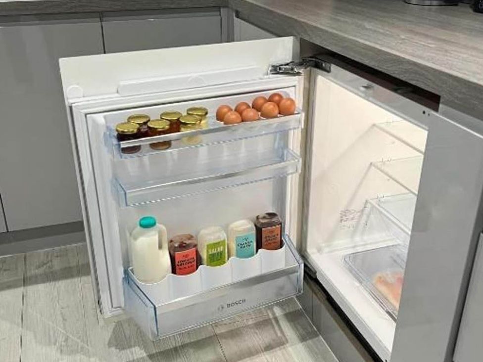 A refrigerator with food items at Family Friendly Apt Sleeps 6 Station Close in Royal Tunbridge Wells