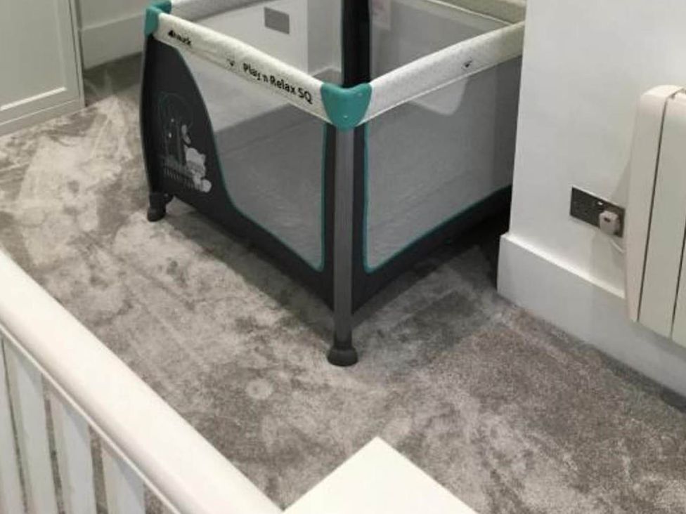 A playpen on a carpet at Family Friendly Apt Sleeps 6 Station Close Royal Tunbridge Wells