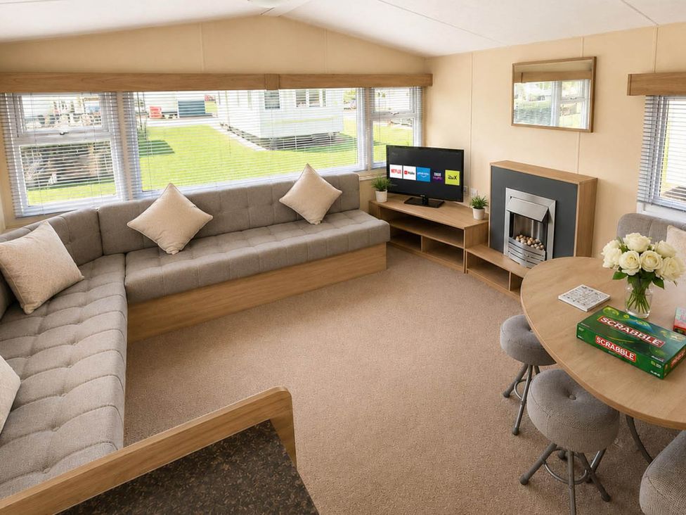 A living room with a sofa and table at Billing Aquadrome Holiday Park 2bed Caravan in Northampton