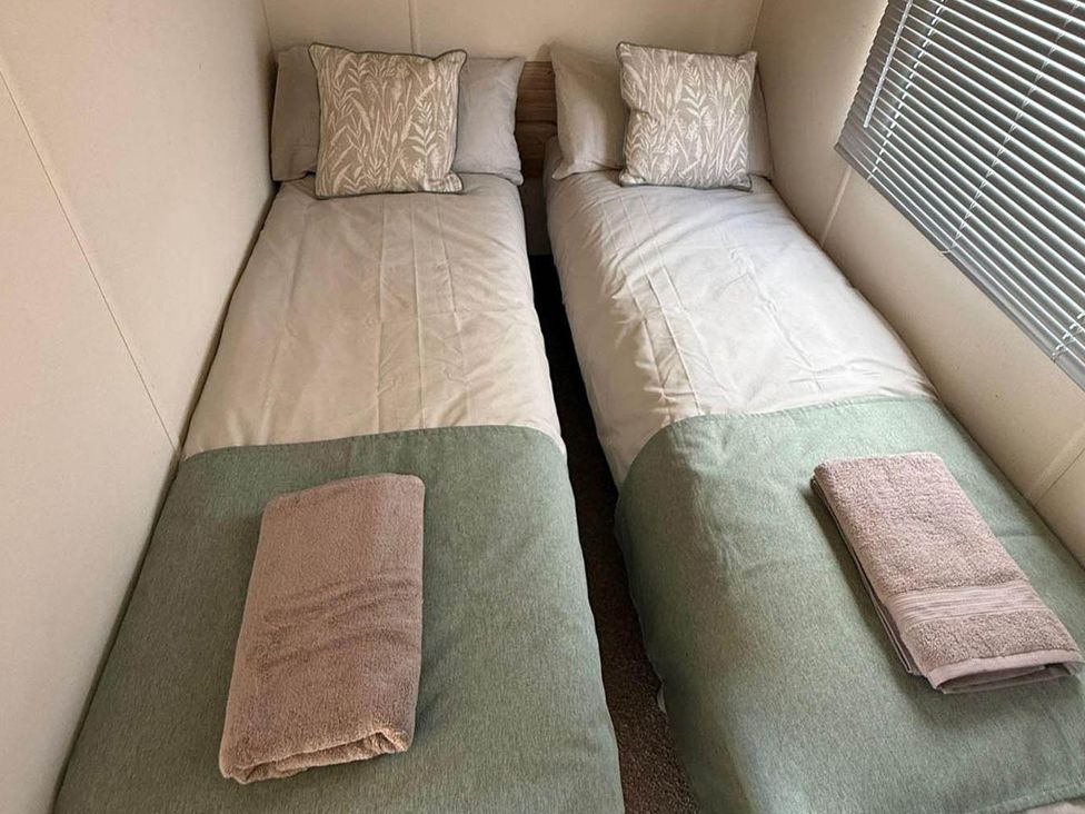 A bedroom with two single beds at Billing Aquadrome Holiday Park 2bed Caravan Northampton