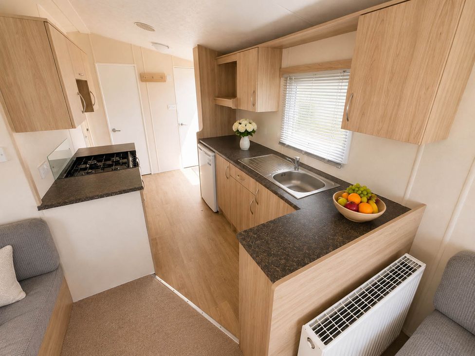 A kitchen with a sink and stove at Billing Aquadrome Holiday Park 2bed Caravan Northampton