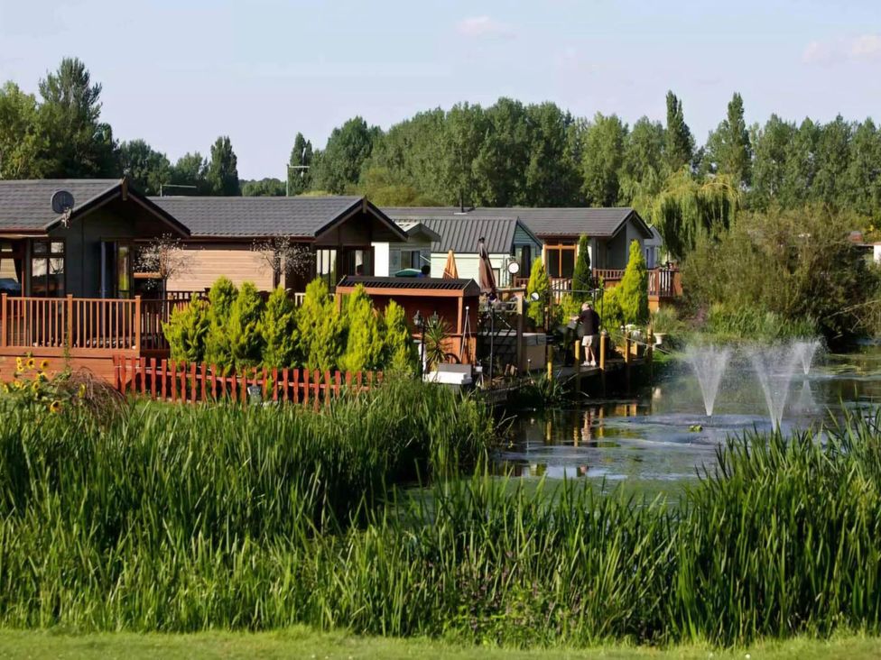 A view of cabins by the water at Billing Aquadrome Holiday Park 2bed Caravan Northampton