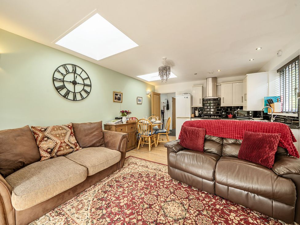 A living room with a sofa and dining area at Cozy Cottage sleeps 4 in Barton upon Humber