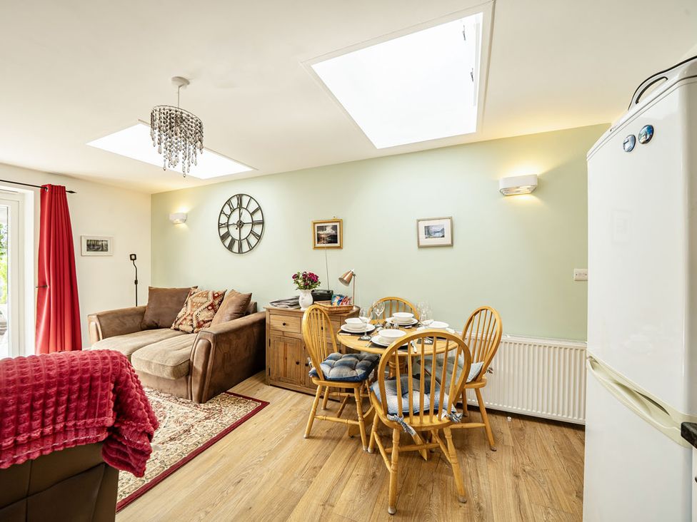 A living room with a sofa and dining area at Cozy Cottage sleeps 4 in Barton upon Humber