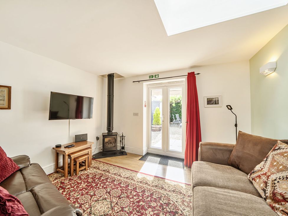 A living room with a television and wood stove at Cozy Cottage sleeps 4 in Barton upon Humber