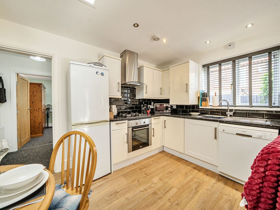 A kitchen with appliances and dining area at Cozy Cottage sleeps 4 in Barton upon Humber