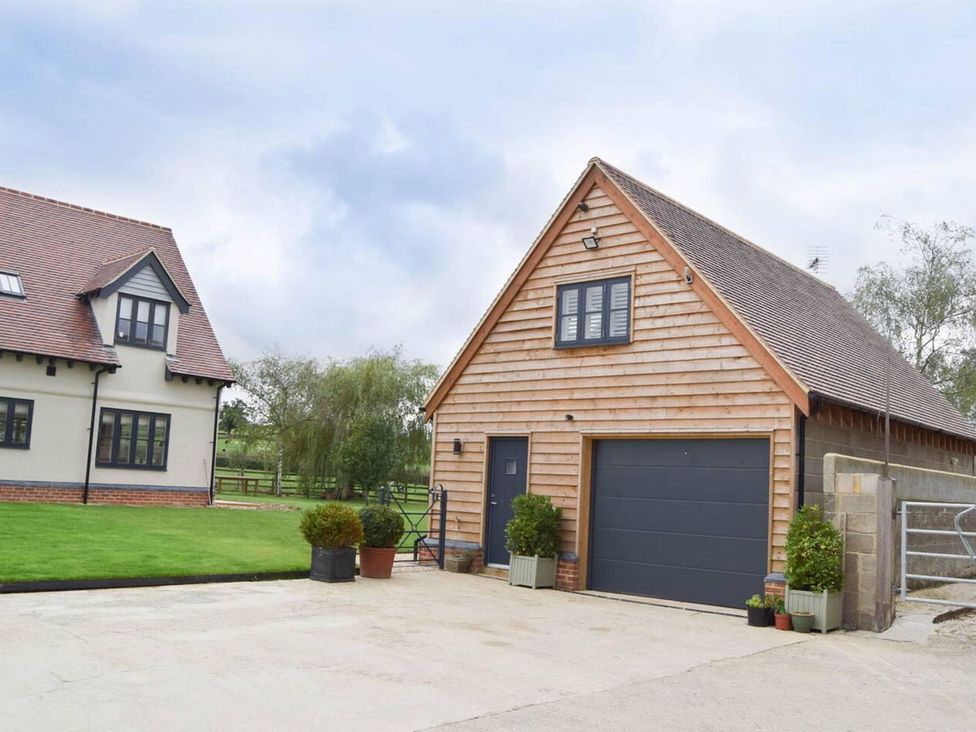 A house and garage with grass area at 1bed Pet Friendly nr Bicester village near Bicester