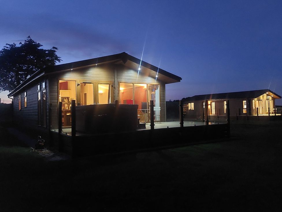 A lodge with deck lights near Lochwinnoch