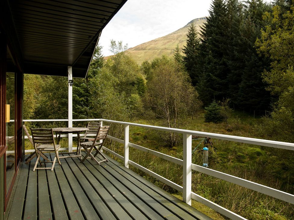 A balcony with table and chairs at a 2 bedroom lodge with free WiFi and mountain view near Crianlarich