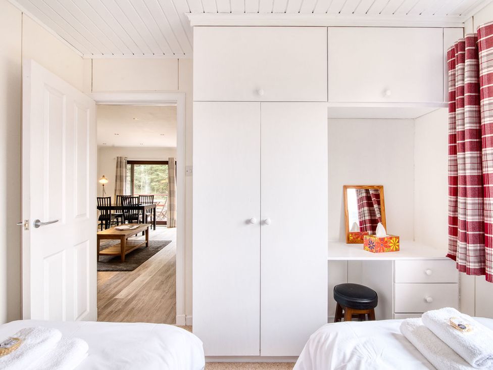 A bedroom with a wardrobe and mirror at 2 bedroom lodge with free WiFi and mountain view near Crianlarich