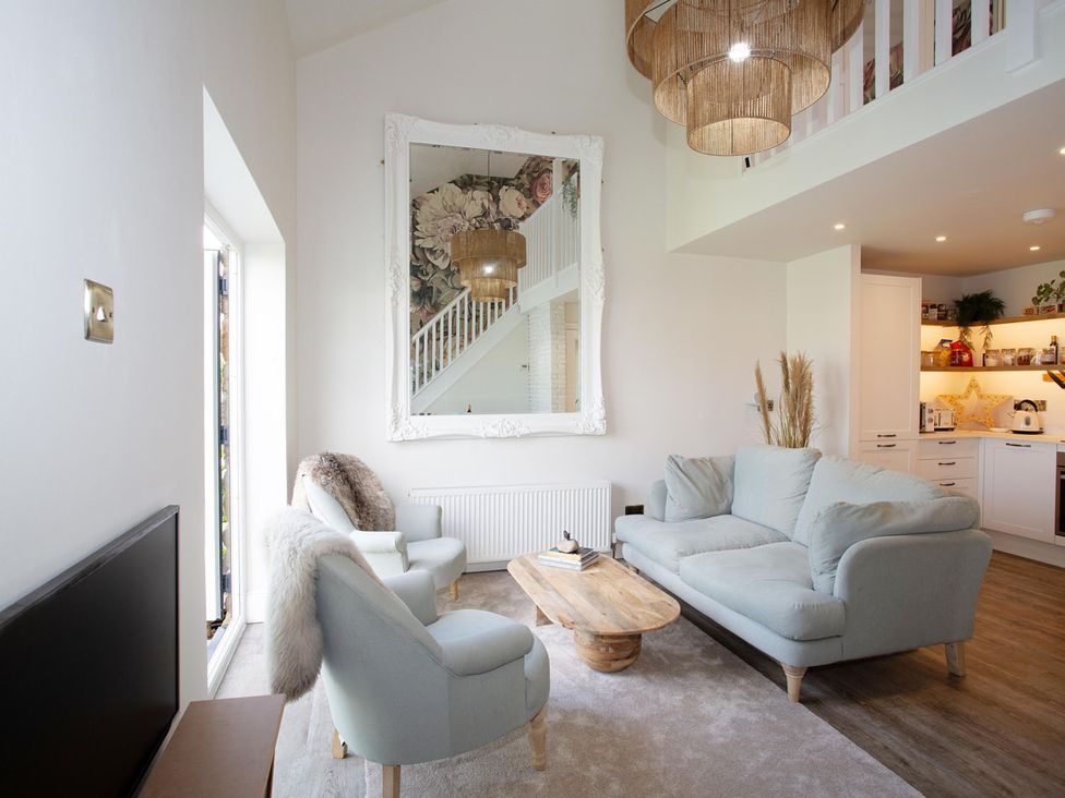 A living room with a sofa and coffee table at Cozy Wetherby Retreat in Wetherby