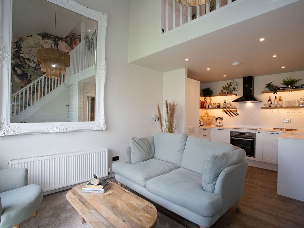 A living room with a sofa and coffee table at Cozy Wetherby Retreat in Wetherby