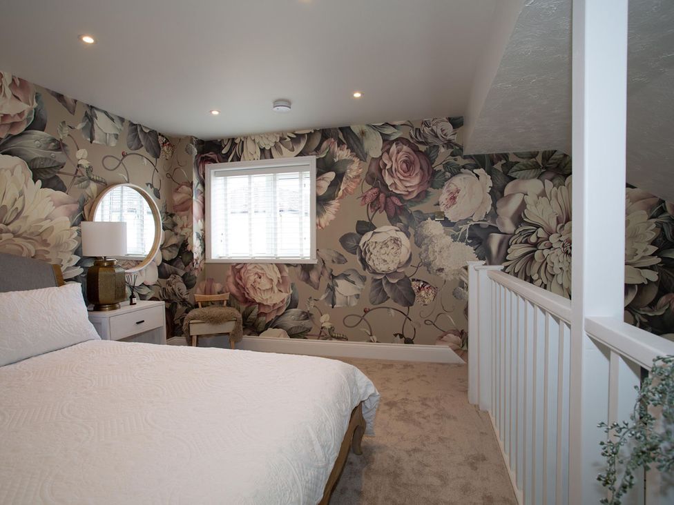A bedroom with a bed and nightstand at Cozy Wetherby Retreat in Wetherby