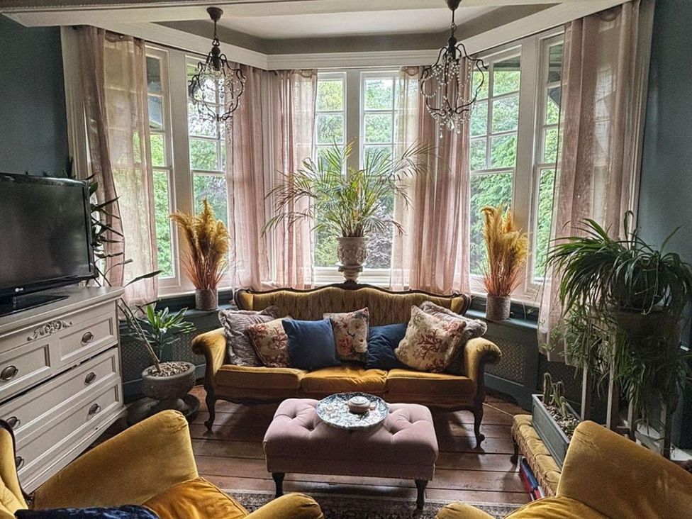 A living room with a sofa and coffee table at the property name in the location