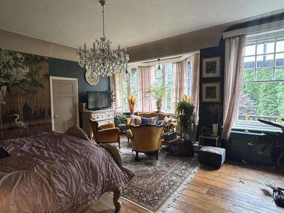 A living room with a sofa and armchairs near a window at a property
