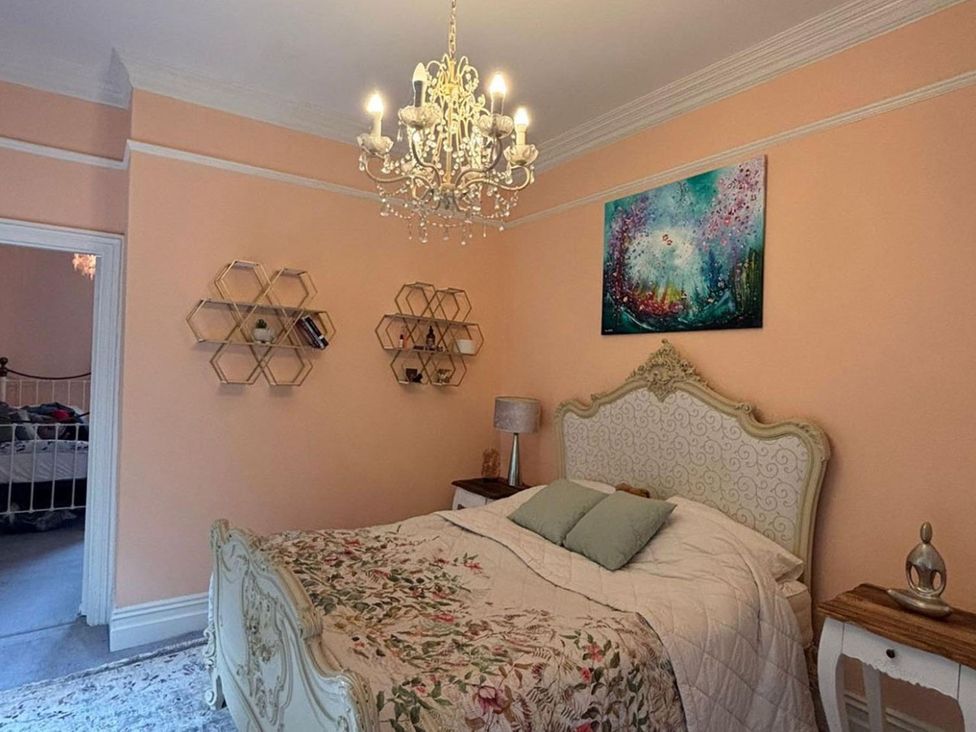 A bedroom with a bed and shelves at 