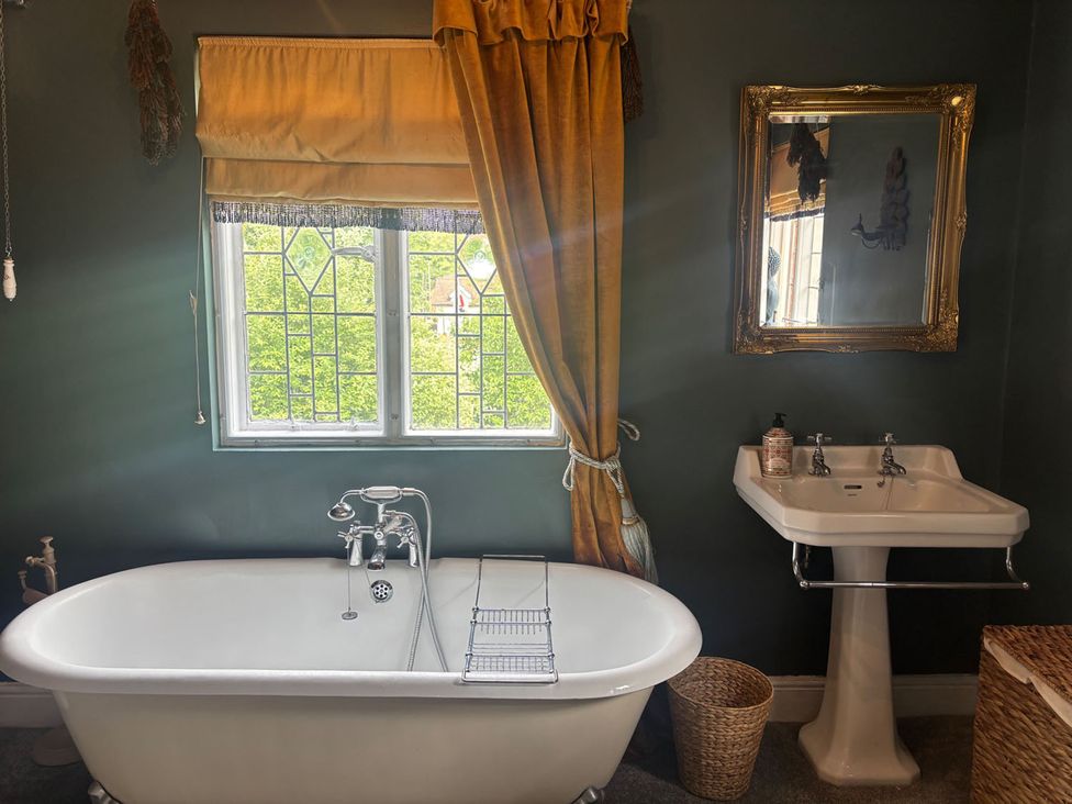 A bathroom with a bathtub and sink at The Old Barn in Manchester