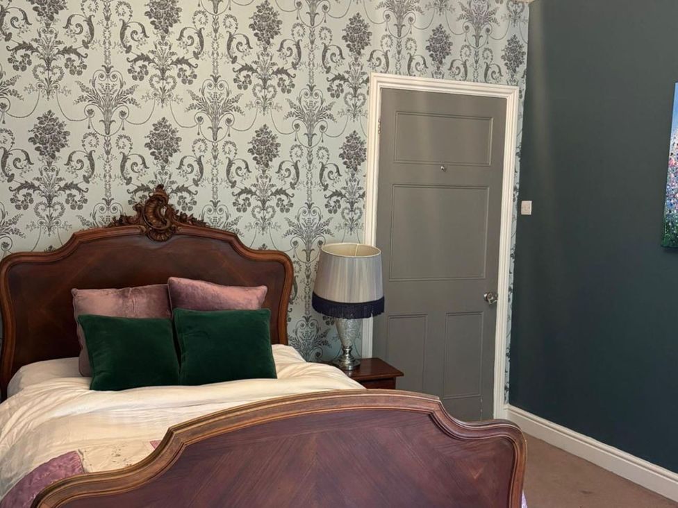 A bedroom with a bed and lamp at 