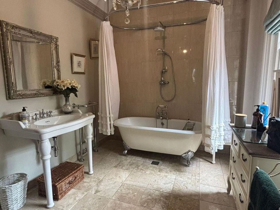 A bathroom with a sink and bathtub at The Old Barn in Manchester