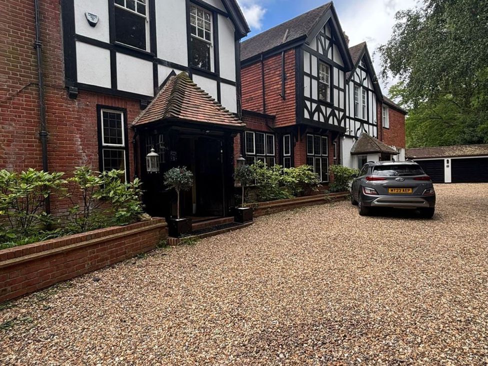 A house with a car parked in the driveway at a residential property