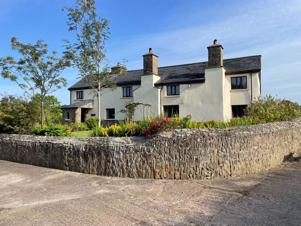 A house with a garden and trees outside at an unspecified location