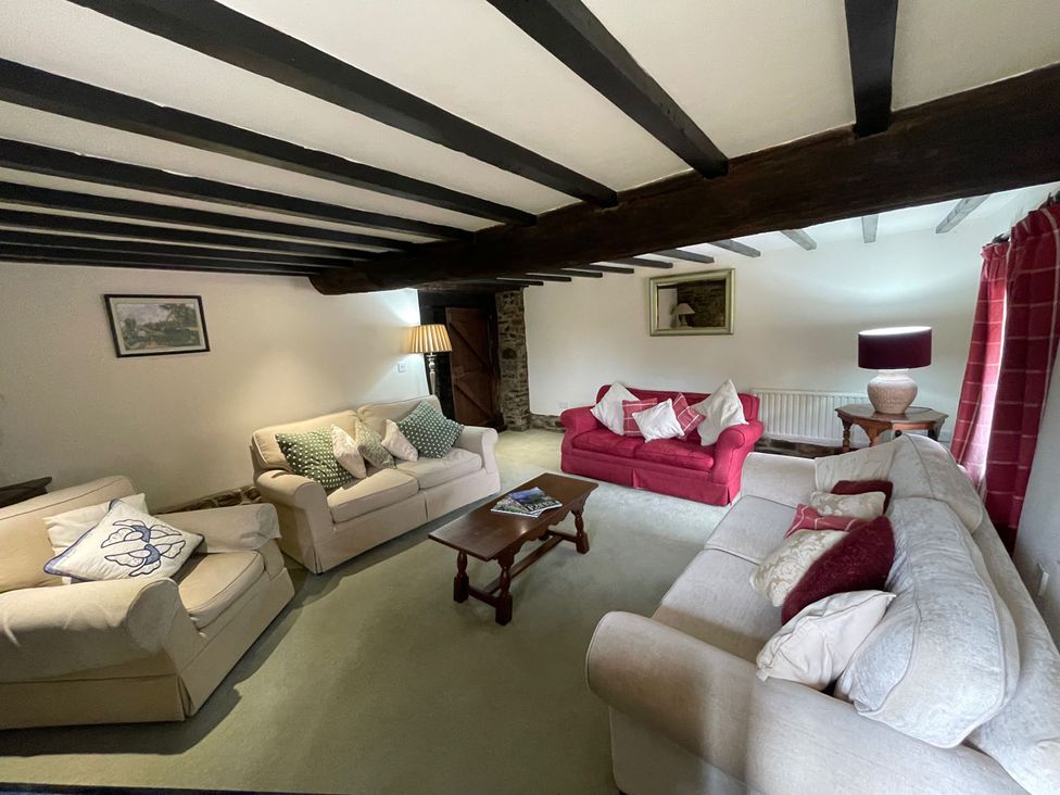 A living room with sofas and a table at The Old Barn in Manchester