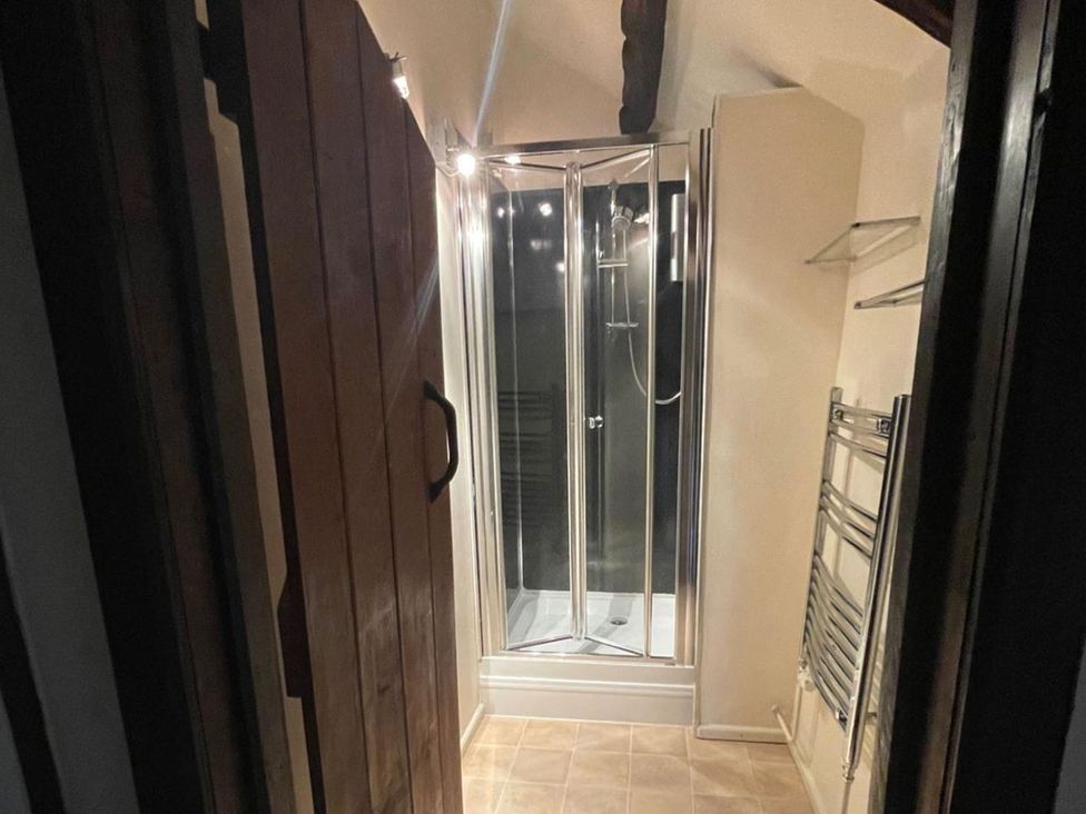 A bathroom with a shower and towel rack at the property in location