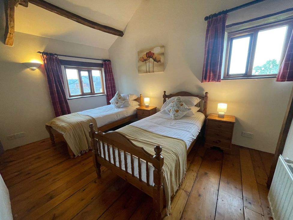 A bedroom with two beds and nightstands at The Old Barn in Manchester
