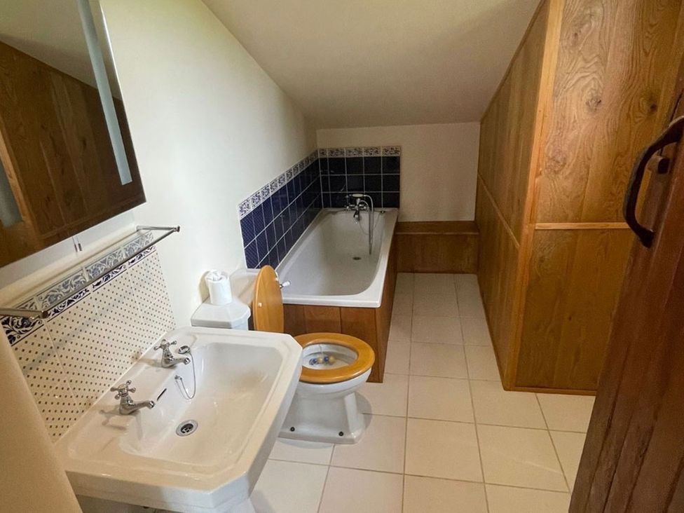 A bathroom with a bathtub, sink, and toilet at the property located in an unknown location