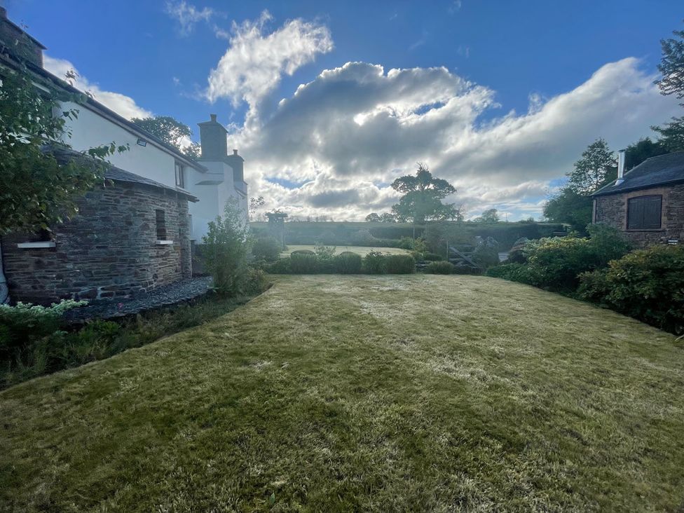 A garden with grass and trees at a property in an outdoor setting