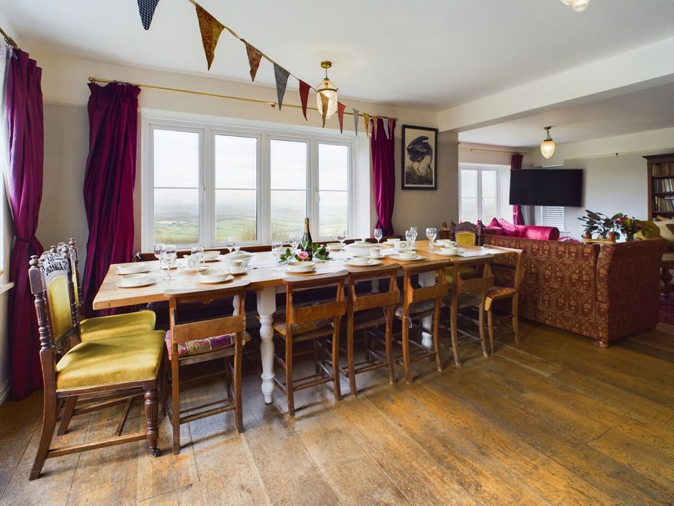 A dining room with a large table set for meals at Country House 14Guests Parking HotTub AmazingViews Kilgwrrwg near Chepstow