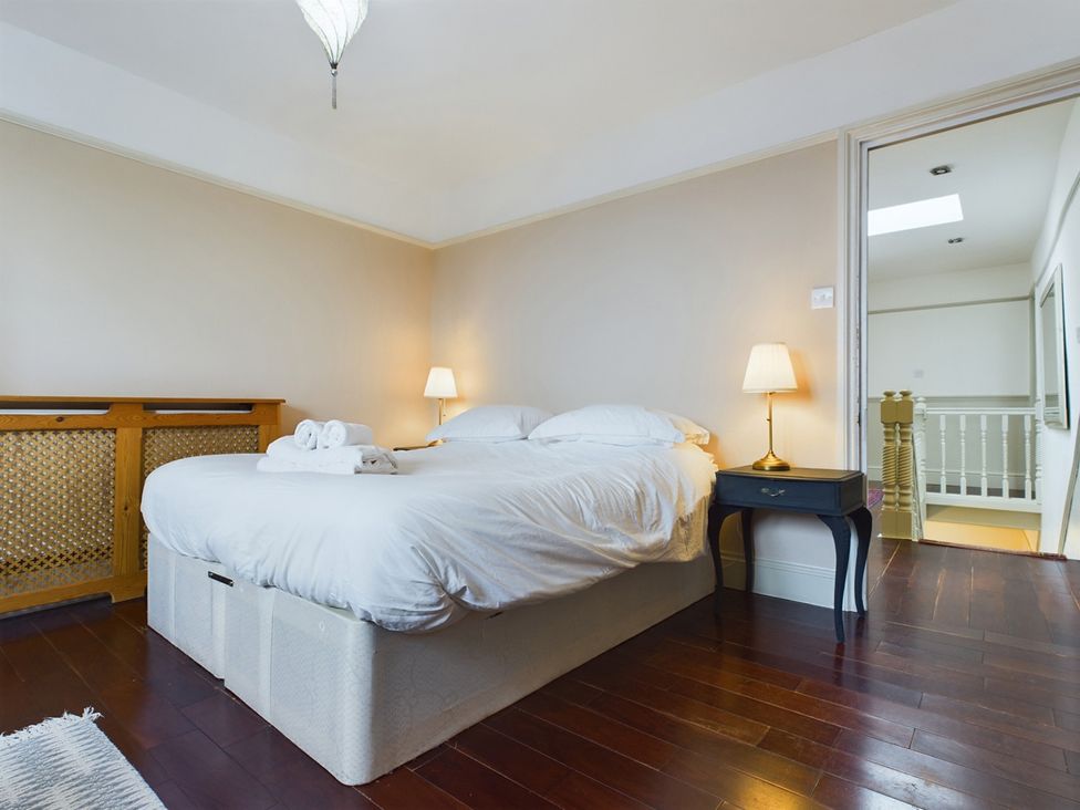 A bedroom with a bed and nightstand at Country House 14Guests Parking HotTub AmazingViews in Kilgwrrwg near Chepstow