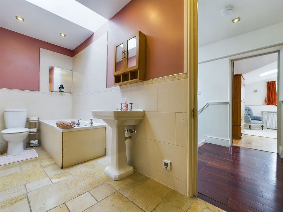 A bathroom with a bathtub and sink at Country House 14Guests Parking HotTub AmazingViews in Kilgwrrwg near Chepstow
