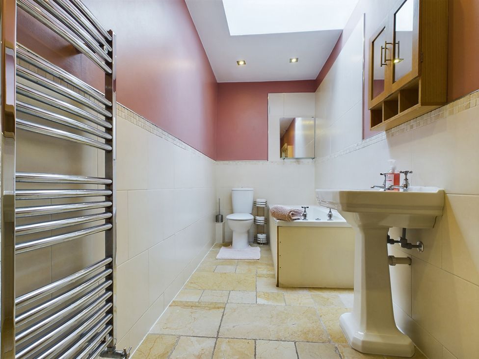 A bathroom featuring a toilet sink bathtub and heated towel rail at Country House 14Guests Parking HotTub AmazingViews Kilgwrrwg near Chepstow