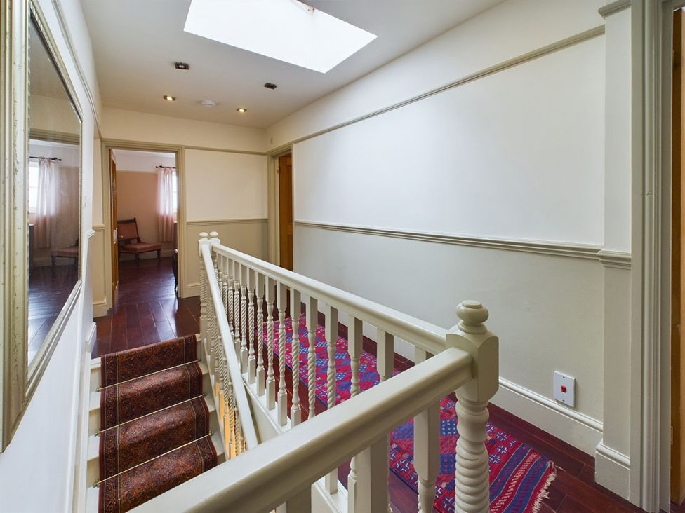 A hallway with a staircase and mirror at Country House 14Guests Parking HotTub AmazingViews, Kilgwrrwg near Chepstow