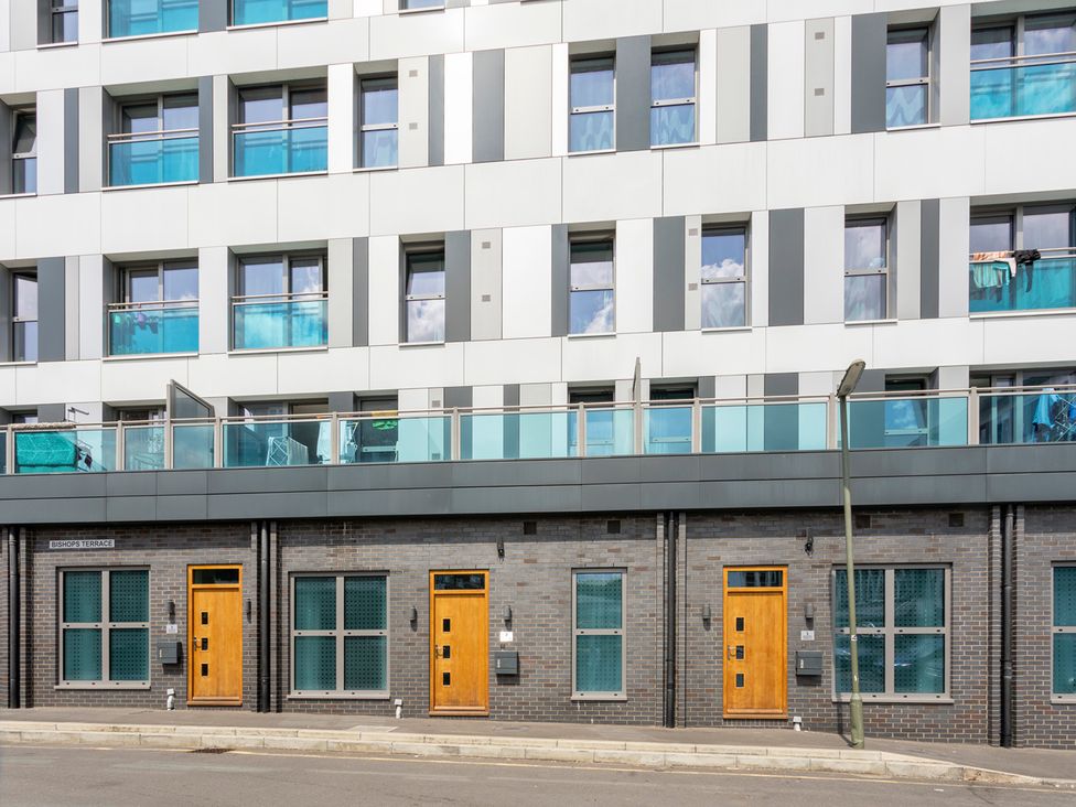 A building facade with balconies and doors at Queens Lodge Sleeps 2 with Welcome Pack Redhill