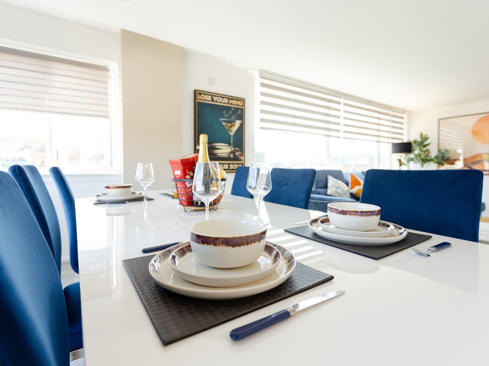 A dining room with table set for dinner at Apartment Sleeps 6 Parking WiFi in Guildford
