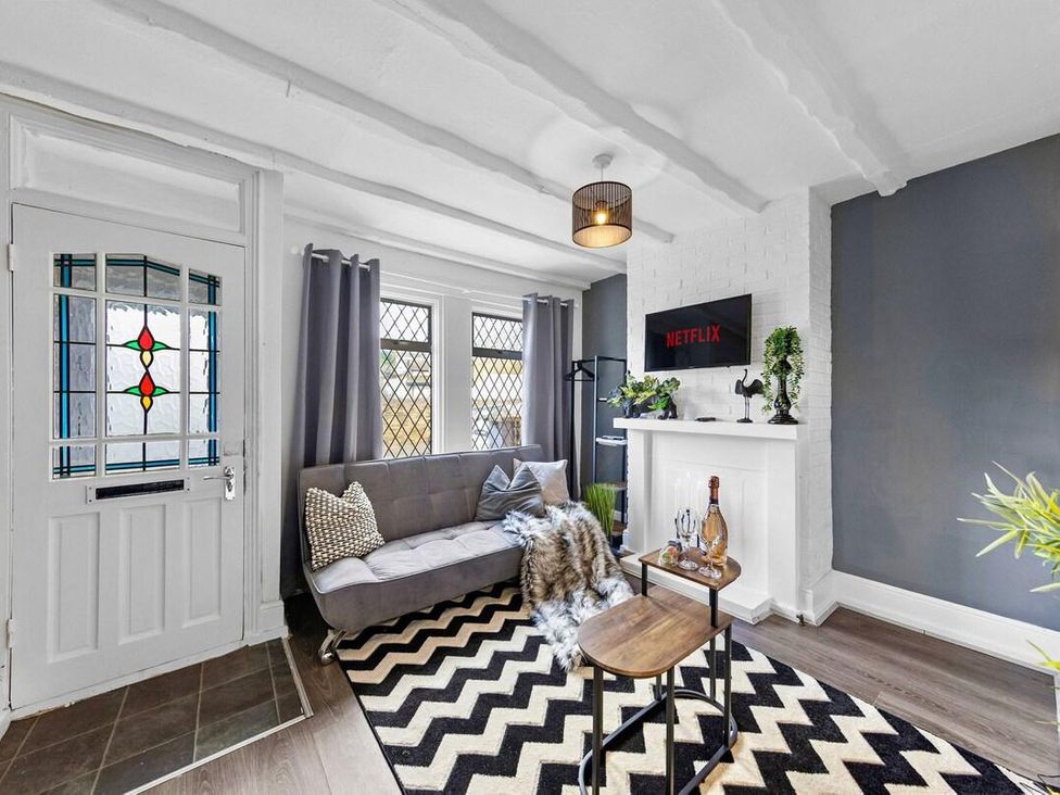 A living room with a grey sofa and a television at Apartment Sleeps 7 with Free Parking in Chatham