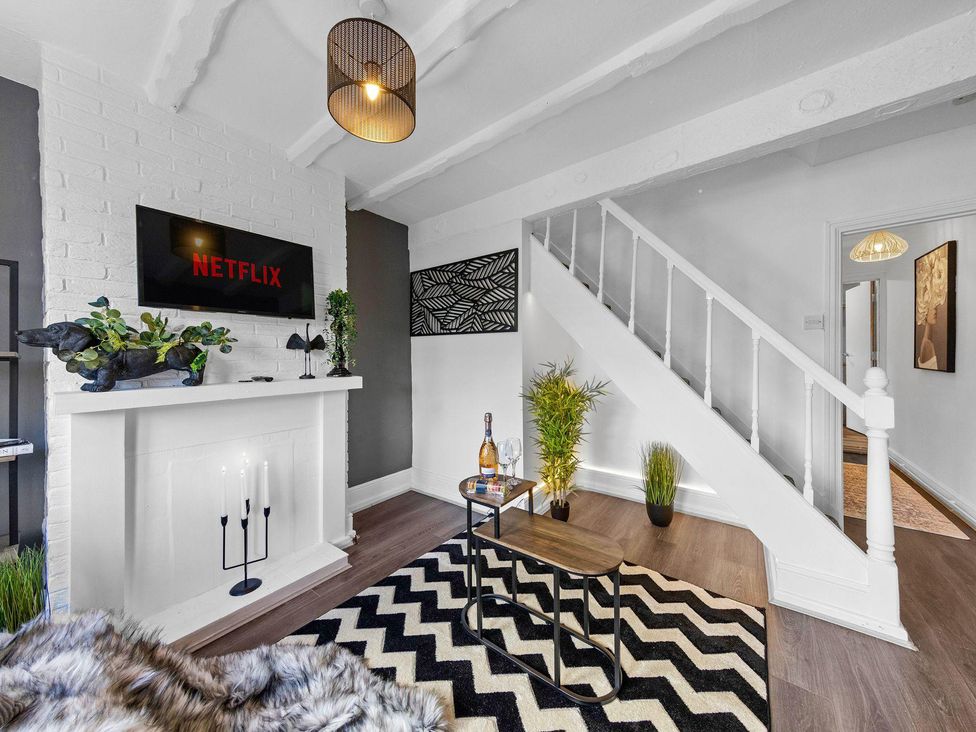 A living room with a television and a coffee table at Apartment Sleeps 7 with Free Parking in Chatham
