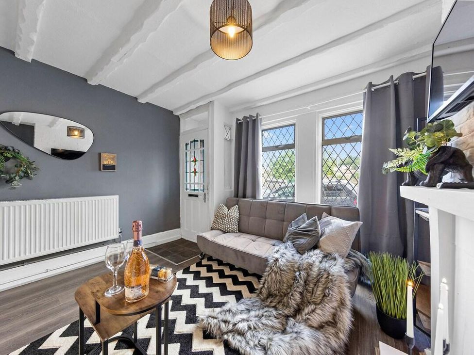 A living room with a sofa and coffee table at Apartment Sleeps 7 with Free Parking, Chatham