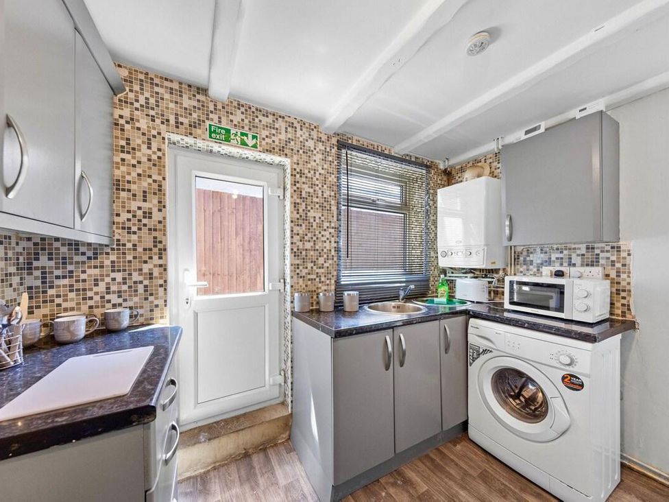 A kitchen with appliances and cupboards at Apartment Sleeps 7 with Free Parking in Chatham