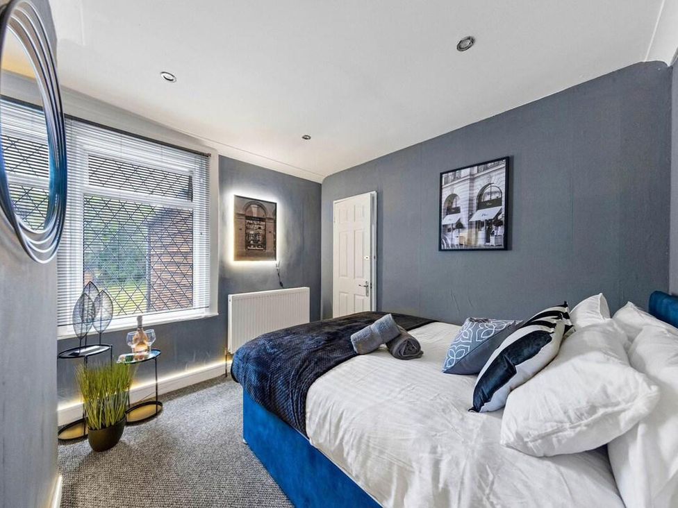 A bedroom with a bed and window at Apartment Sleeps 7 with Free Parking in Chatham