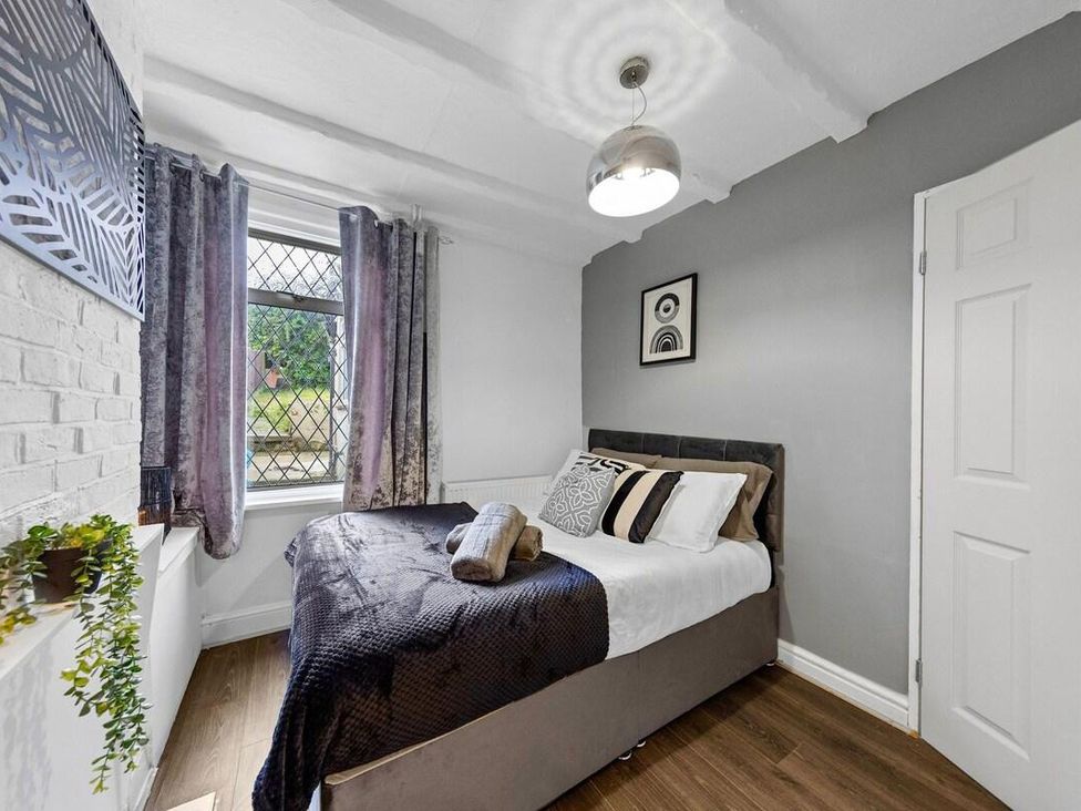 A bedroom with a bed and window at Apartment Sleeps 7 with Free Parking in Chatham