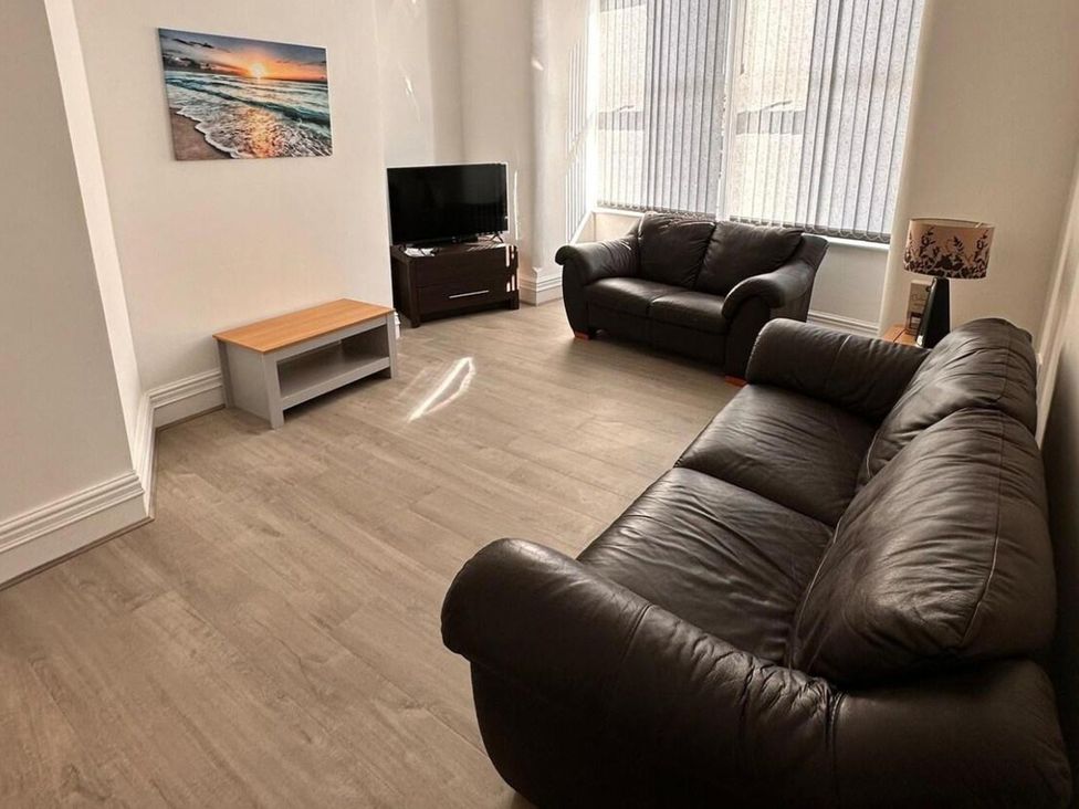 A living room with a sofa and television at Near Beach Parking WiFi Sleeps 2 in Lytham St Annes