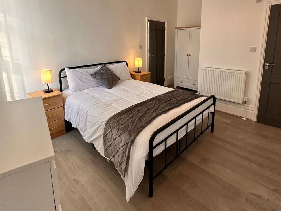 A bedroom with a bed and nightstands at Near Beach Parking WiFi Sleeps 2 Lytham St Annes