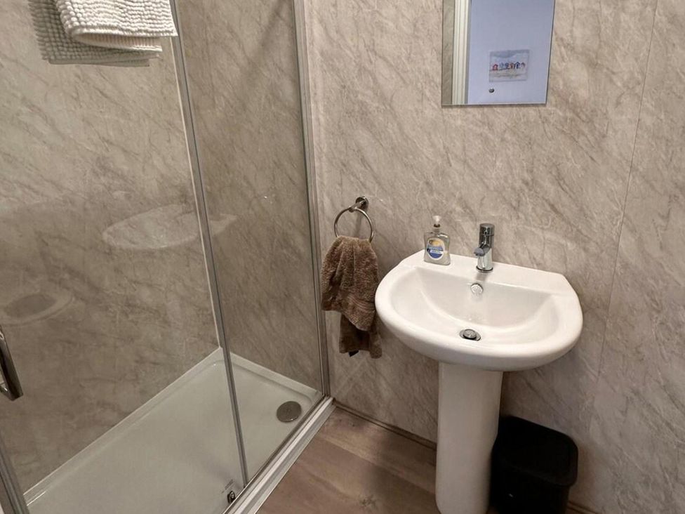 A bathroom with a shower and sink at Near Beach Parking WiFi Sleeps 2 Lytham St Annes