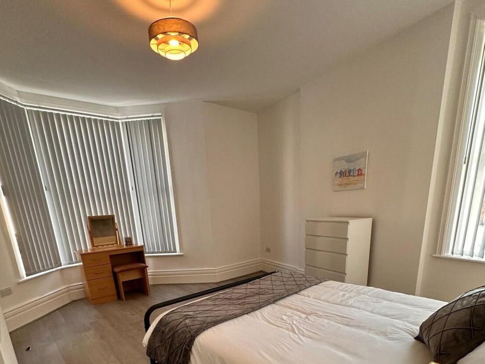 A bedroom with a bed, drawer, and a mirror at Near Beach Parking WiFi Sleeps 2 Lytham St Annes